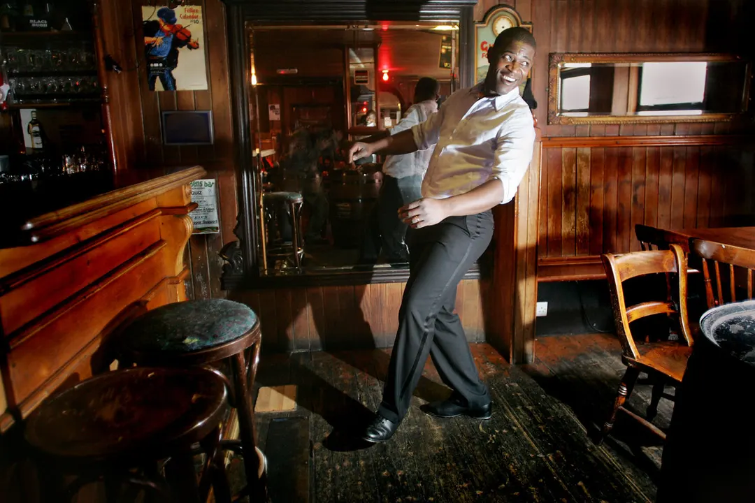 Tura Arutura dancing on the wooden floor of a pub